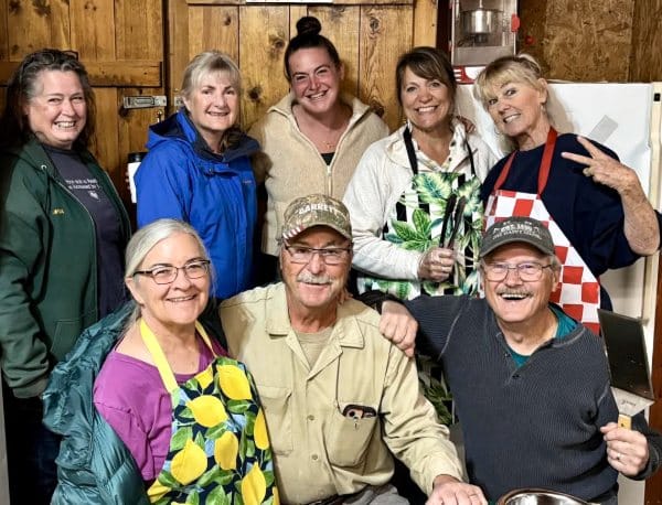 seniors laughing and preparing food together in community kitchen at Earth Keepers
